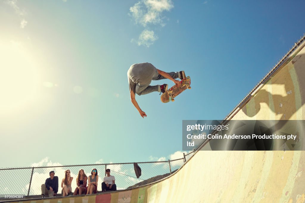 Man performing trick on skateboard at skate park