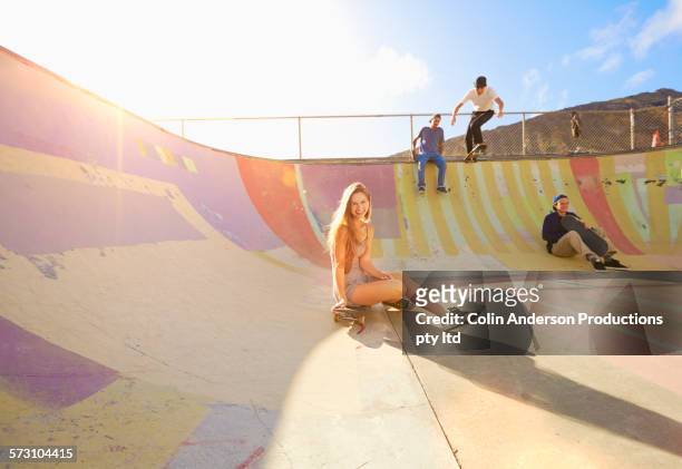 friends relaxing on ramp in skate park - skateboard park stock pictures, royalty-free photos & images