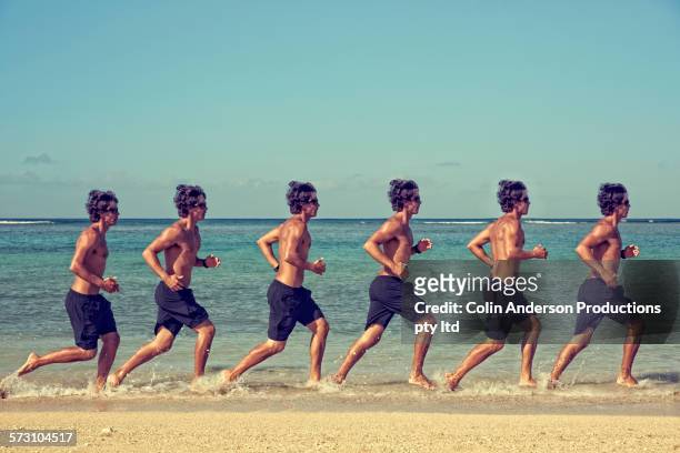 multiple exposure of caucasian man running on beach - double exposure running stock-fotos und bilder
