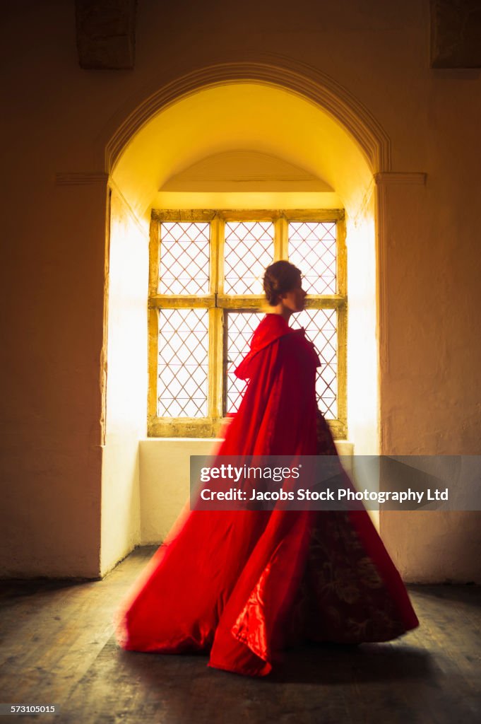 Caucasian woman in medieval costume walking in castle