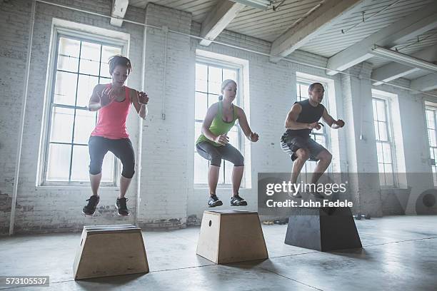 athletes jumping on platforms in gym - positionner bildbanksfoton och bilder