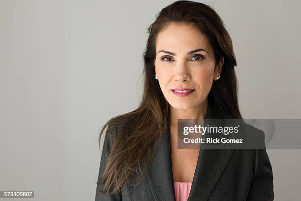 close up of serious hispanic businesswoman - brown hair isolated stock pictures, royalty-free photos & images