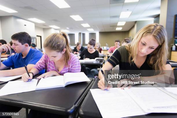 students taking test in classroom - exam results stock-fotos und bilder