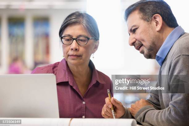 business people using computer in library - filipino ethnicity and female not male fotografías e imágenes de stock