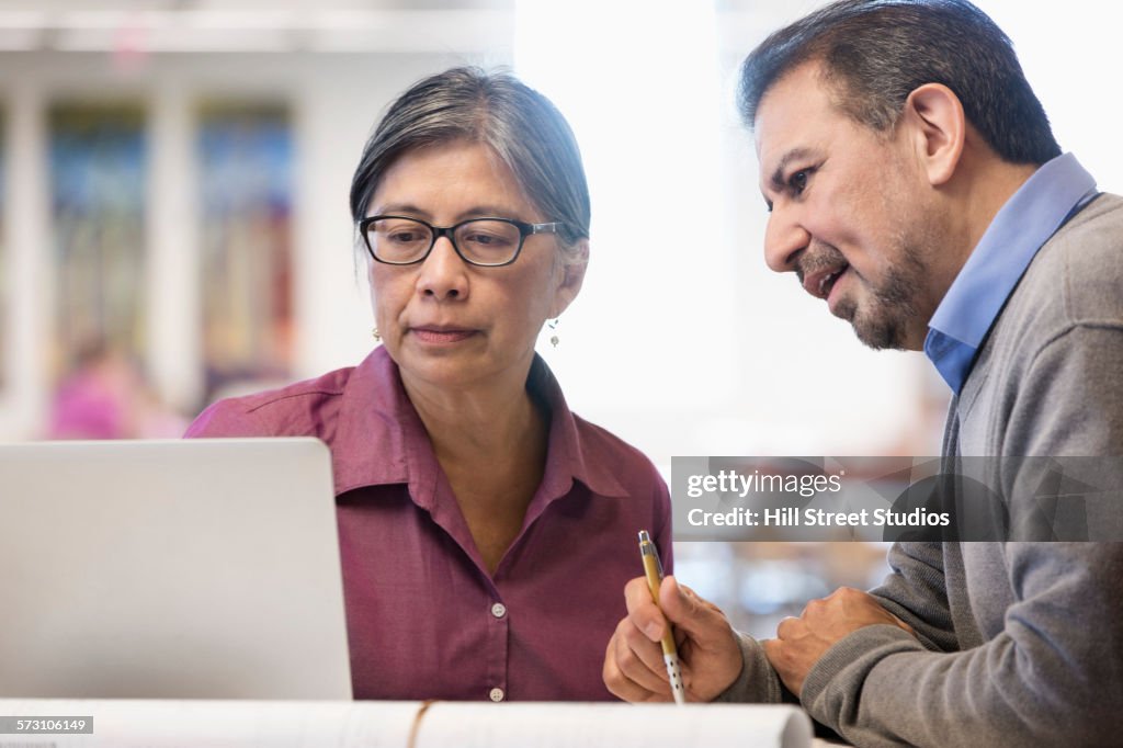 Business People Using Computer In Library High-Res Stock Photo - Getty ...