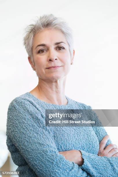 close up of caucasian woman with arms crossed - hill street studios bildbanksfoton och bilder