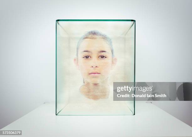 hologram of mixed race girl in glass box - hologramm stock-fotos und bilder
