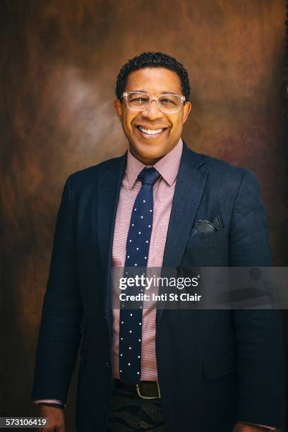 mixed race businessman smiling - mixed race man standing studio stockfoto's en -beelden