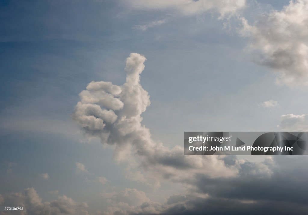 Clouds forming thumbs-up shape in sky