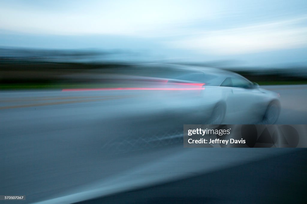 Blurred view of car driving on road