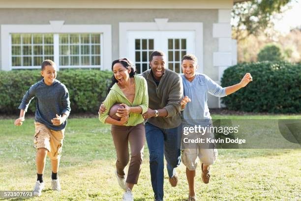 family playing football in backyard - football américain femme photos et images de collection