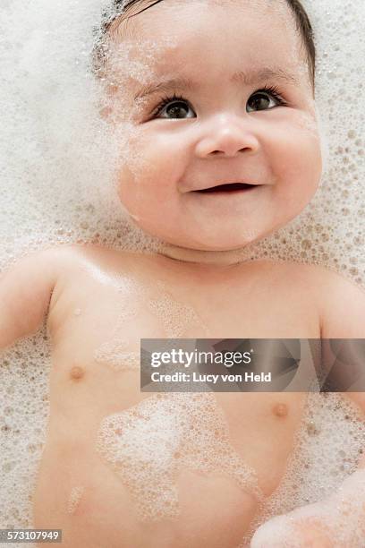 close up of mixed race baby in bubble bath - bubblebath stock pictures, royalty-free photos & images