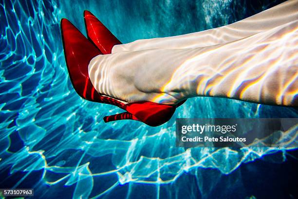 legs of woman wearing high heels in swimming pool - bainbridge island wa stock pictures, royalty-free photos & images