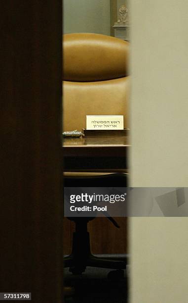 APRIl 11: The empty chair of ailing Israeli Prime Minister Ariel Sharon is seen through the doors prior to a special meeting of the cabinet at the...