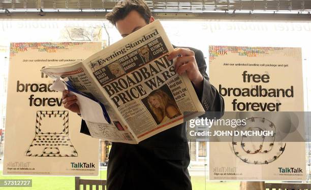 United Kingdom: A customer reads a newspaper in a Carphone Warehouse store in London, 11 April 2006. Carphone Warehouse challenged British Telecom...