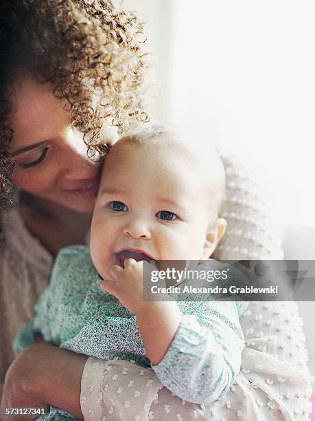 mother holding baby and smiling - alexandra mora bildbanksfoton och bilder