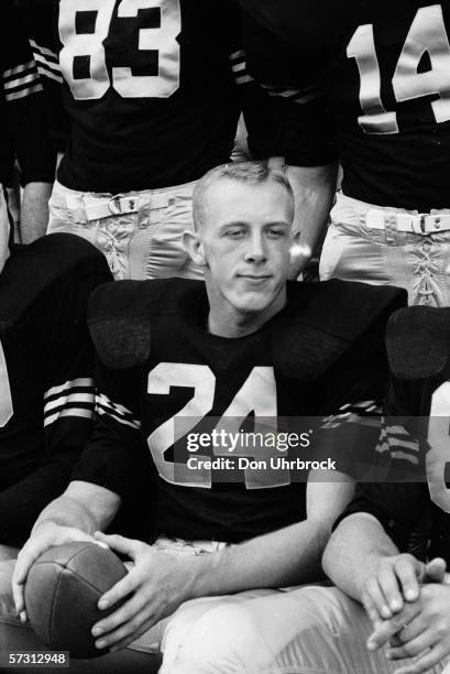 Close-up of American West Point student and football player Pete Dawkins as he poses, ball in his hands, with his teammates, West Point. New York,...