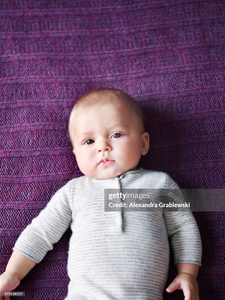 Baby Laying On Purple Blanket