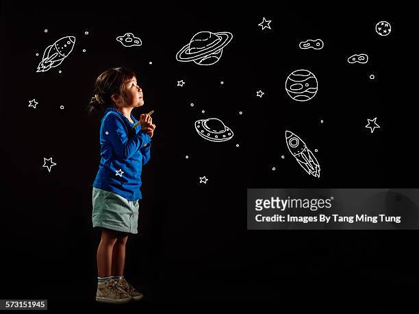 little girl drawing universe on black background - kids astronomy stock pictures, royalty-free photos & images