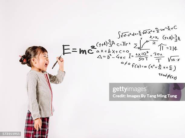 little girl writing equations on white background - einstein stock pictures, royalty-free photos & images