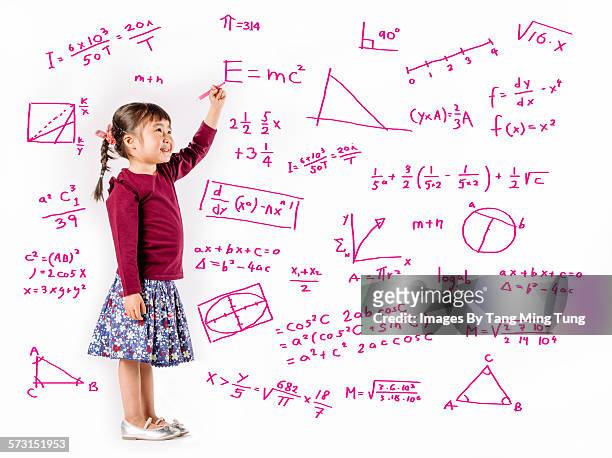 little girl writing equations on white background - einstein stock-fotos und bilder
