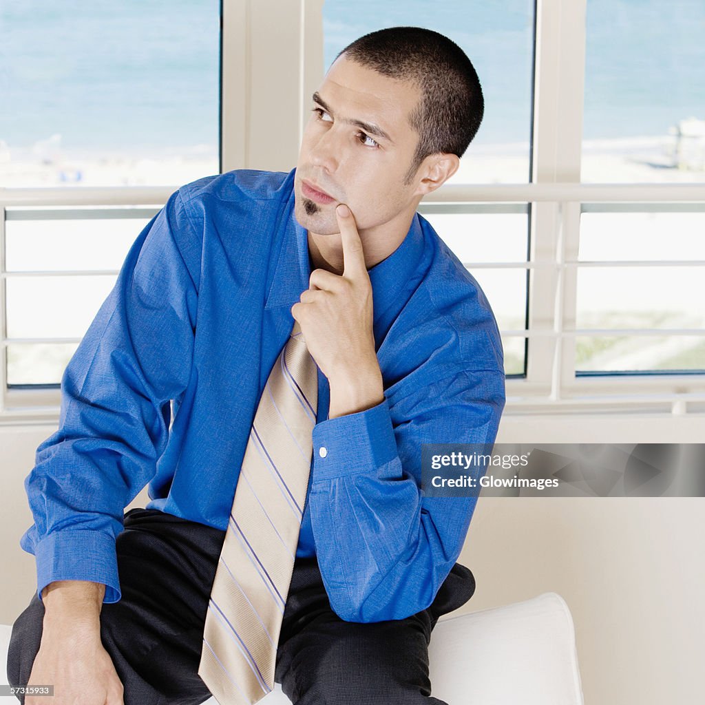 Close-up of a businessman sitting on a couch