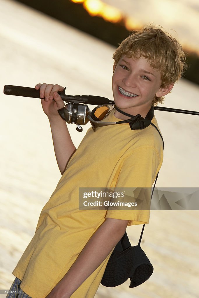 Close-up of a teenage boy holding a fishing rod