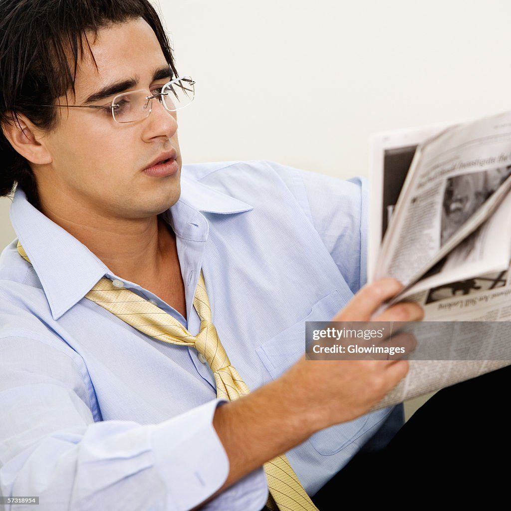 Close-up of a businessman reading a newspaper