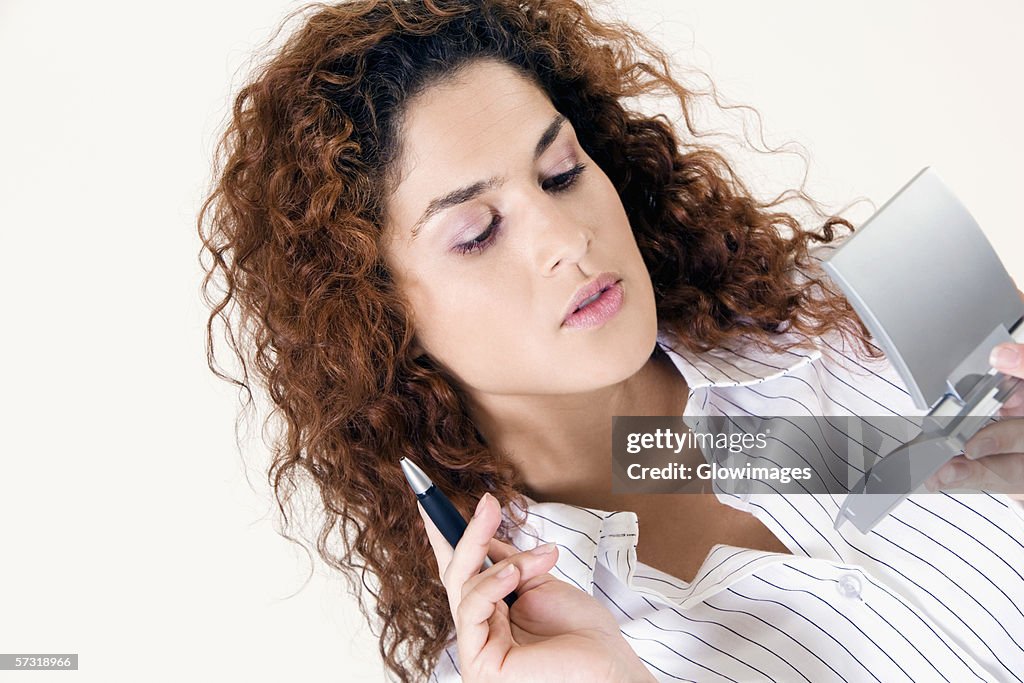 Close-up of a young woman working with a calculator