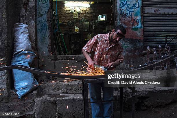 An Egyptian blacksmith is working the steel in the slum district of Manshiyat Nasser in Cairo.