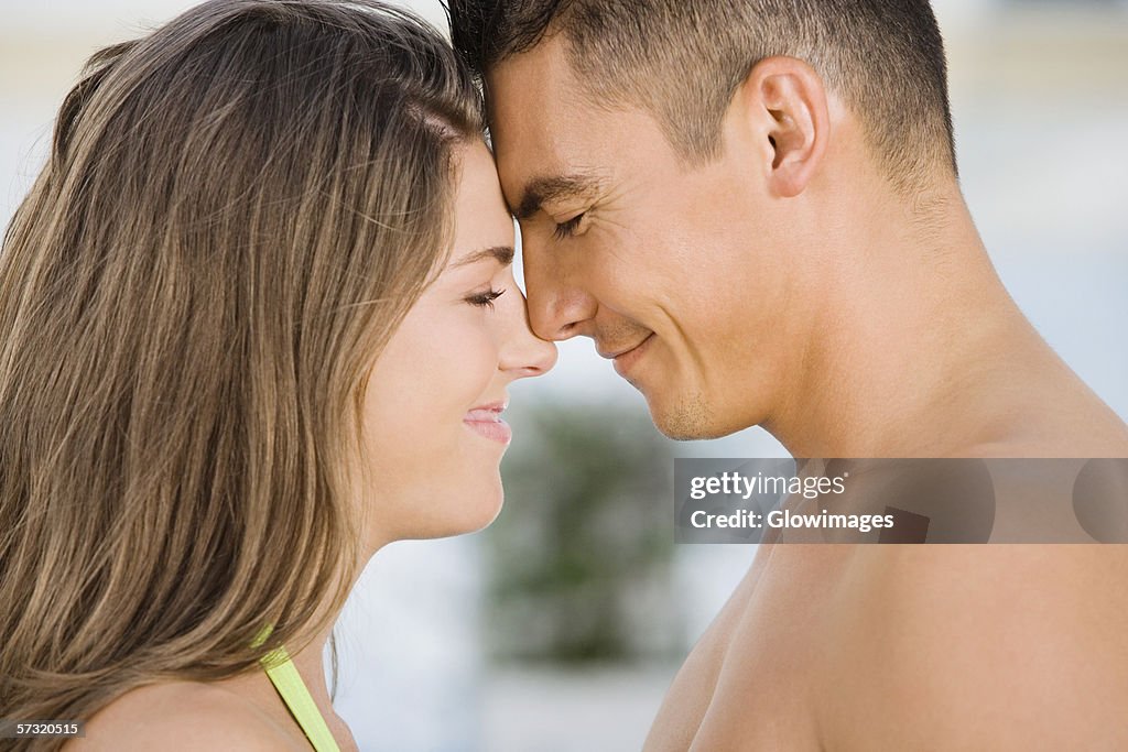 Side profile of a young couple rubbing their noses