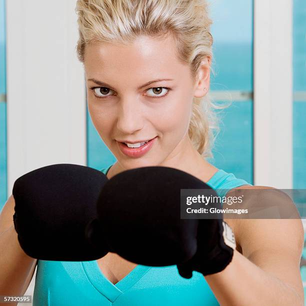 close-up of a young woman wearing boxing gloves - belly punching stock pictures, royalty-free photos & images