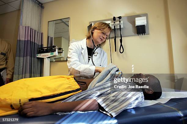 Dr. Maura Shea uses a stethoscope during an examination of patient Michelo Cineas at the Codman Square Health Center April 11, 2006 in Dorchester,...