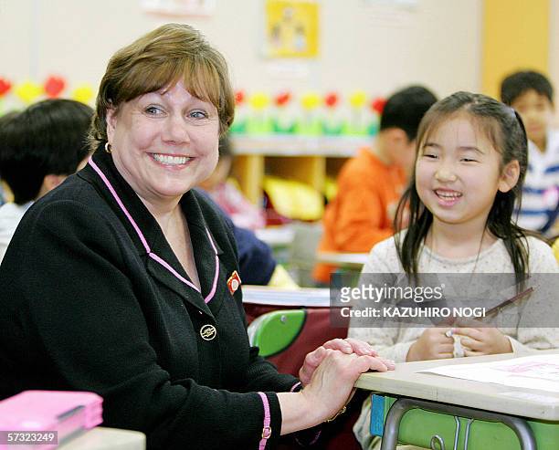 United Nations International Children's Emergency Fund executive director Ann Veneman chats with a schoolgirl as part of her visit to Tokyo's...
