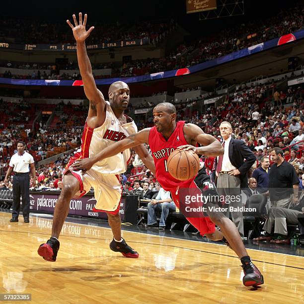 Mike James of the Toronto Raptors drives against Gary Payton of the Miami Heat on April 11, 2006 at American Airlines Arena in Miami, Florida. NOTE...