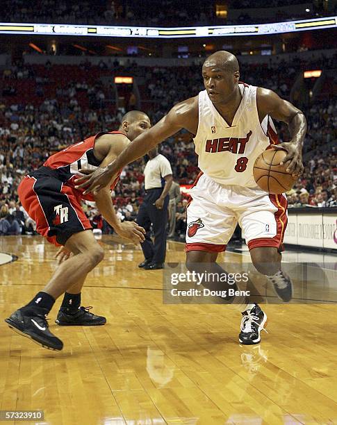 Antoine Walker of the Miami Heat gets past Mike James of the Toronto Raptors on April 11, 2006 at American Airlines Arena in Miami, Florida. NOTE TO...