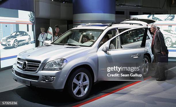 Visitors check out the new Mercedes-Benz GL500 SUV at DaimlerChrysler's annual general shareholder's meeting April 12, 2006 in Berlin, Germany....