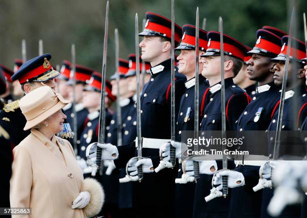Queen Elizabeth II as proud grandmother smiles at Prince Harry as she inspects soldiers at their passing-out Sovereign's Parade at Sandhurst Military...