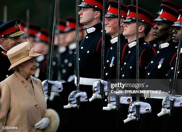 Sandhurst, UNITED KINGDOM: Britain's Queen Elizabeth II smiles with her grandson Prince Harry during the Sovereign's Parade at the Royal Military...