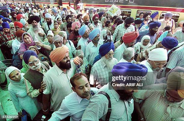 Indian Sikh pilgrims enter the immigration hall upon their arrival at the Wagha border post, 11 April 2006, on their way to participate in an annual...