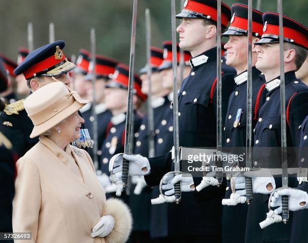 Queen Elizabeth II as proud grandmother smiles at Prince Harry as she inspects soldiers at their passing-out Sovereign's Parade at Sandhurst Military...