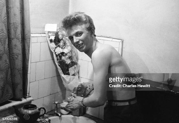 English pop idol Tommy Steele washes his hands at his parents' home in Frean Street, Bermondsey, where he still lives, 25th February 1957. Original...