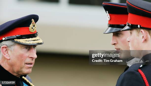 Prince William in uniform as an officer cadet, chats with his brother and Prince Charles, Prince of Wales at the Sovereign's Parade at Sandhurst...