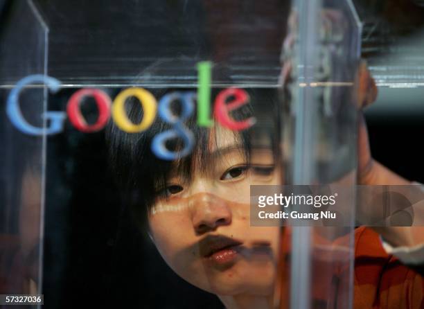 Women polishes a dais before the Google global Chinese name launch on April 12, 2006 in Beijing, China. Google said it has adopted the...