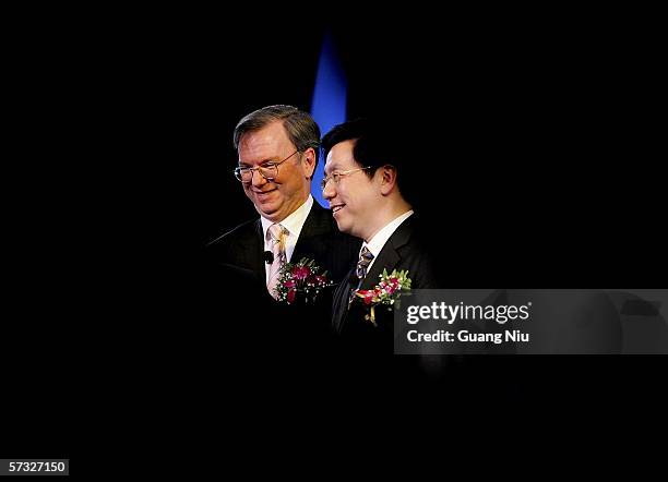 Google chief executive Eric Schmidt is seen through a stage curtain with Vice President, Engineering and President of Google China Kai-Fu Lee during...