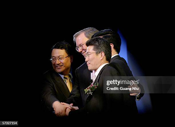 Google chief executive Eric Schmidt is seen through a stage curtain with his Chinese team leaders during the inauguration of the company new Chinese...