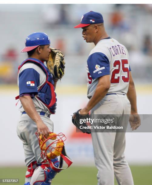 Jorge Cortez and Carlos Ruiz of Panama meet on the mound on March 8, 2006 during the game against Cuba at Hiram Bithorn Stadium in San Juan, Puerto...