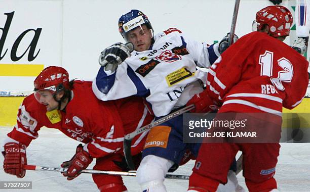Denmark's Rasmus Pander and his teammate Peter Regin stop Andrej Kmec of Slovakia during a friendly match betweeen Slovakia and Denmark in Piestany,...
