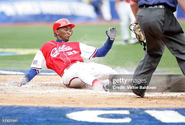 Alexei Ramirez of Cuba slides into home during the game against Panama on March 8, 2006 at Hiram Bithorn Stadium in San Juan, Puerto Rico.