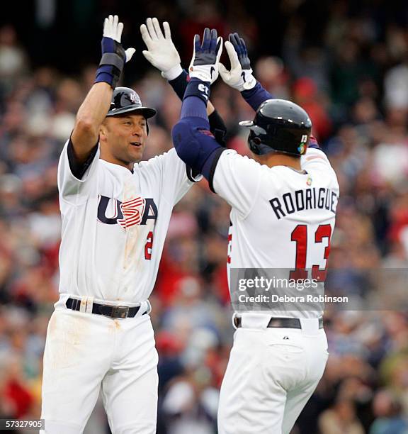 Derek Jeter and Alex Rodriguez of USA celebrate Rodriguez' game winning single during the game against Japan on March 12, 2005 at Angels Stadium in...